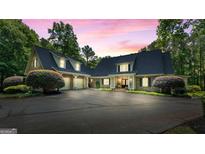 Elegant two-story brick home featuring a spacious driveway and manicured landscaping at 130 Allie Dr, Mcdonough, GA 30252