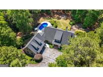 Stunning aerial view of a well-maintained home featuring a swimming pool, hot tub, and backyard fire pit at 130 Allie Drive, Mcdonough, GA 30252