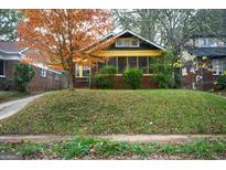 Charming brick home with a inviting screened porch and a lovely fall-colored tree in the front yard at 1660 Rogers Sw Ave, Atlanta, GA 30310