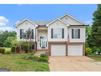 Charming two-story home features a brick-accented facade, two-car garage, and well-maintained landscaping at 175 Dove Pt, Covington, GA 30016