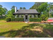 Charming home featuring a covered front porch, manicured landscaping, and a lush green lawn at 332 Judy Dr, Mcdonough, GA 30253