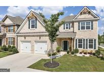 Charming brick two-story home with a well-manicured lawn, two-car garage and attractive architectural details at 3970 Lagrone St, Powder Springs, GA 30127