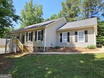 Charming single-story home featuring stone accents, a well-maintained lawn, and a welcoming facade at 105 Old Hickory Pointe, Mcdonough, GA 30252