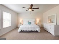 A bright main bedroom features a ceiling fan, carpeted floor and white furnishings at 2358 Argento Cir, Dacula, GA 30019