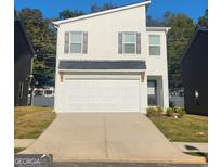 Charming two-story home with a white painted brick exterior and a spacious two-car garage at 4838 Station Lane # 15, Union City, GA 30349