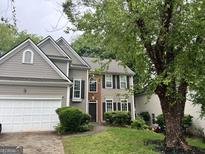 Charming two-story home with a two-car garage and well-maintained front yard at 3838 Kirkwood Nw Run, Kennesaw, GA 30144