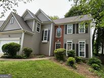 Charming two-story home showcasing neutral siding and complementary black shutters at 3838 Kirkwood Nw Run, Kennesaw, GA 30144