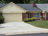 Charming brick home with a well-manicured lawn and a convenient attached garage at 6190 Douglas Manor Ct, Douglasville, GA 30134