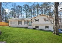 Charming two-story home with a well-manicured lawn and mature trees offers excellent curb appeal at 2511 Due West Nw Cir, Kennesaw, GA 30152