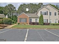 Charming townhome featuring brick accents, manicured landscaping and convenient parking at 1801 Ridgefield Dr, Peachtree City, GA 30269