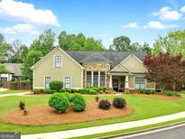 Charming one-story home features a well-manicured lawn and inviting landscaping at 3174 Piney Woods Cir, Buford, GA 30519