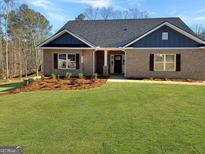 Charming brick home with a well-manicured lawn and welcoming front entrance at 3402 Milan Ct # 1 Plapprox Sqft 2, Douglasville, GA 30135
