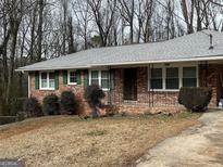 Charming brick home with green shutters and a well-maintained front yard at 1858 Sahara Se Dr, Atlanta, GA 30316