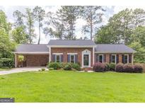 Charming brick home with well-manicured lawn and landscaping at 2118 Allaire Ne Ln, Atlanta, GA 30345
