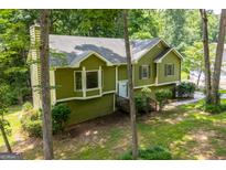 Charming green split-level home surrounded by mature trees at 133 Deerfield Ln, Carrollton, GA 30116