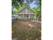 Charming house featuring a welcoming front porch with large white columns and horizontal railing at 937 Sw Metropolitan Sw, Atlanta, GA 30310
