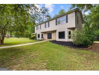Charming two-story home boasts a manicured lawn, complementing its inviting facade and classic design at 101 Jasmine Path, Peachtree City, GA 30269