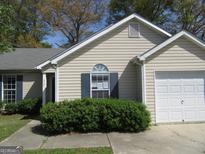 Inviting single-story home with light siding, dark shutters, and a well-maintained front yard at 5799 Eagles Feather Ln, Riverdale, GA 30274