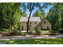 Charming home featuring classic architectural design with a lush, mature landscape at 1260 Heards Ferry Rd, Sandy Springs, GA 30328