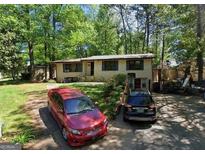 Charming single-story home with a well-maintained lawn and driveway at 1071 Ponderosa Park Dr, Forest Park, GA 30297