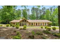 Charming single-story brick home with a stone accent and a well-maintained landscaped front yard at 200 Whitney Way, Fayetteville, GA 30214