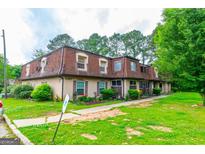 Charming townhomes with red roofing and well-maintained green lawn at 2986 Parc Lorraine, Lithonia, GA 30038