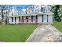 Charming one-story home with a brick facade, complemented by a well-manicured lawn and inviting front porch at 5219 Maple Valley Sw Rd, Mableton, GA 30126
