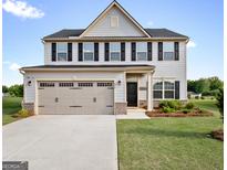 Charming two-story home featuring a gray exterior, black shutters, and a spacious two-car garage at 838 Maduro Way, Mcdonough, GA 30253