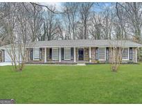 Charming brick home with a well-manicured front yard and classic design elements at 4313 Executive Dr, Stone Mountain, GA 30083