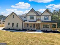 Inviting two-story home with a welcoming front porch and well-manicured landscaping at 1461 Leach Dr, Lawrenceville, GA 30045
