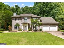 Two-story home with a landscaped front yard and attached two-car garage at 224 Claridge Curv, Peachtree City, GA 30269