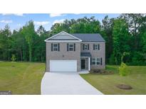 Charming two-story home with a brick facade, well-manicured lawn, and attached two-car garage at 1483 Autumn Wind Dr # 24, Dacula, GA 30019