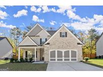 Charming two-story home with a brick and siding exterior, covered porch, and well-manicured lawn at 1511 Arica Ave, Lawrenceville, GA 30043