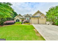Charming home with a well-manicured lawn, stone accents, and a spacious three-car garage at 3435 Vista Creek Dr, Dacula, GA 30019