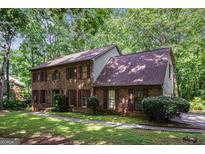 Charming brick two-story home with mature trees and lush landscaping at 275 Brandon Mill Cir, Fayetteville, GA 30214