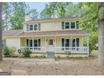 Charming two-story home with a covered front porch and lovely green shutters at 101 Bluegill Trce, Peachtree City, GA 30269
