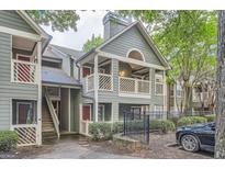 Charming condo exterior features a private balcony, mature landscaping, and a convenient parking area at 578 Mcgill Ne Pl # 578, Atlanta, GA 30312