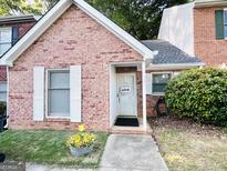 Charming brick home featuring a welcoming front door with a decorative wreath and well-maintained landscaping at 120 Williamsburg Way, Fayetteville, GA 30214