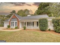 Charming one-story home with white siding, brick accents, and a welcoming front porch at 70 Summer Walk Dr, Covington, GA 30016