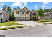 Charming two-story home featuring a three-car garage, well-manicured lawn, and inviting curb appeal at 71 Pacific Ave, Sharpsburg, GA 30277