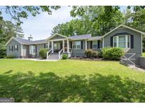 Charming ranch-style home with a well-maintained lawn and inviting entrance at 105 Greenfield Cir, Fayetteville, GA 30215