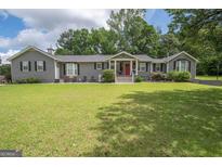 Charming ranch home with a well-manicured lawn and inviting front porch at 105 Greenfield Cir, Fayetteville, GA 30215