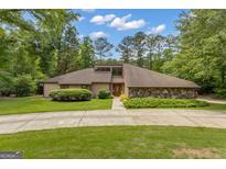 Charming single-story home with stone accents, inviting curb appeal, and a well-manicured lawn at 105 Gleneagles Pt, Peachtree City, GA 30269
