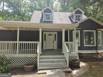 Charming front porch welcomes you to this home with white railings and a classic white front door at 686 Favorwood Sw Dr, Marietta, GA 30060