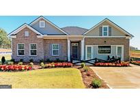 Charming single-story home with brick and siding, professional landscaping, and a welcoming front entrance at 1278 Hollingsworth Way # 39, Dacula, GA 30019