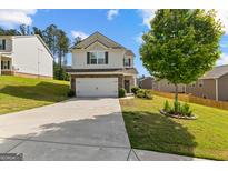 Charming two-story home featuring a well-maintained lawn and a spacious two car garage at 1003 Nandina Ct, Villa Rica, GA 30180