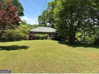 Sprawling front lawn and landscaped greenery highlight this charming single-story home at 2942 Old Norcross Rd, Tucker, GA 30084