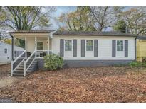 Charming single-story home with a welcoming front porch and gray shutters at 1865 Broadwell Sw St, Atlanta, GA 30310