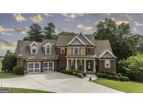 Charming two-story brick home with a well-manicured lawn, a two-car garage, and inviting front porch at 9742 Fallview Ct, Villa Rica, GA 30180