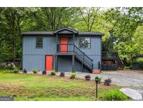 Inviting two-story home featuring a modern exterior with bright orange doors at 1772 Martin Se Pl, Smyrna, GA 30080